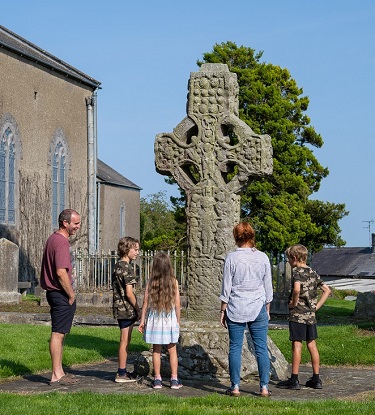 Family looking at Kells High Cross