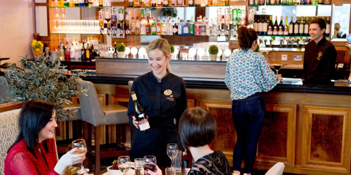 Two women being served at the Bailey Bar in Trim Castle Hotel